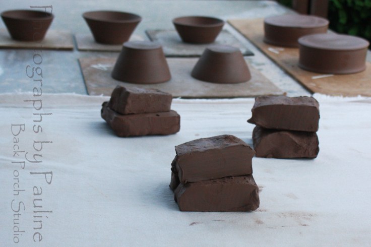 Kitchen prep bowls in the background.  Three two pound lumps of clay ready to wedge.